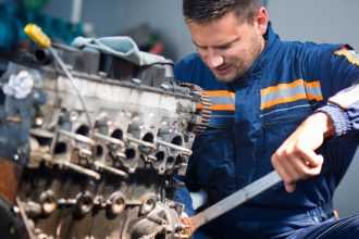 a man repairing a diesel engine